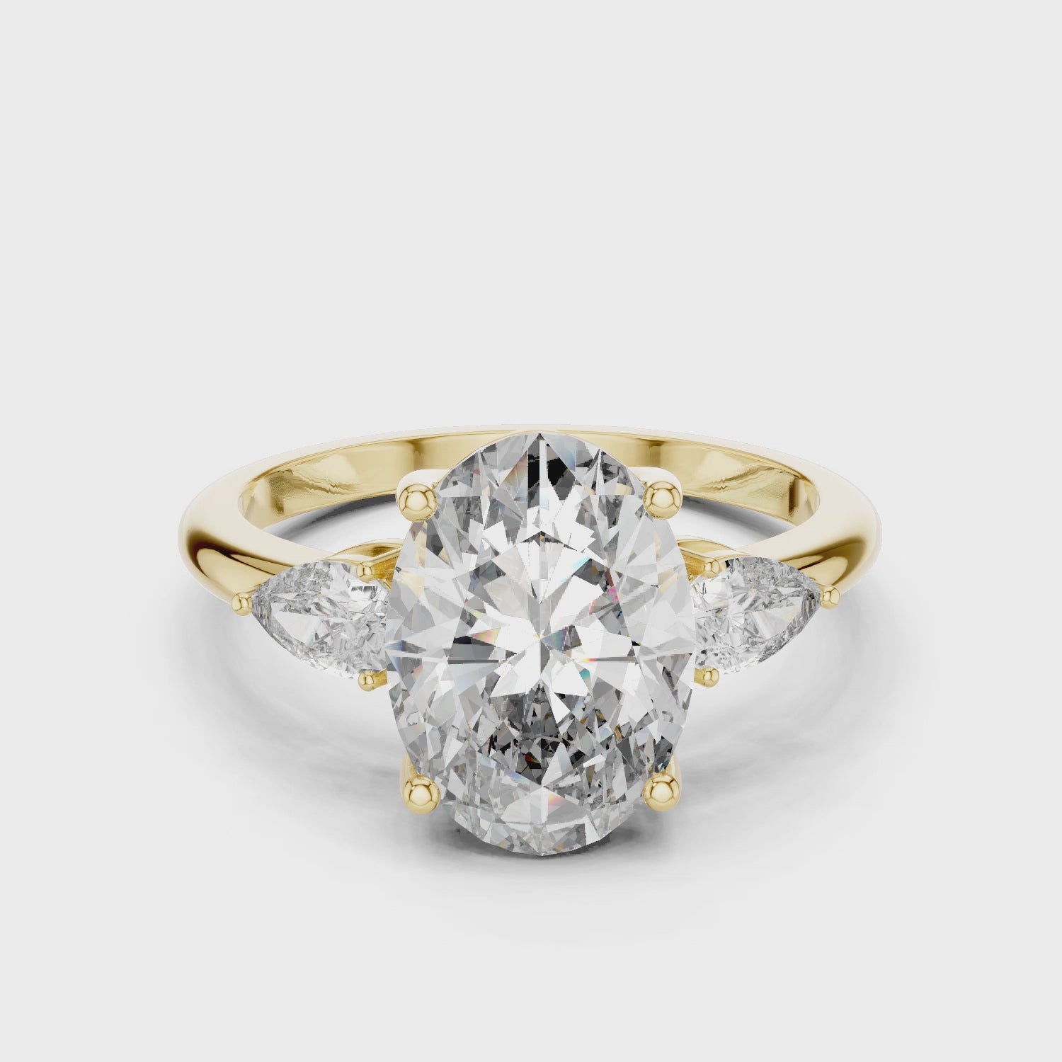 Oval Three-Stone Engagement Ring with Pear Accents